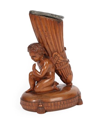 Lot 336 - A Carved Walnut Cornucopia Vase, in Empire style, modelled as a kneeling putto supporting the...