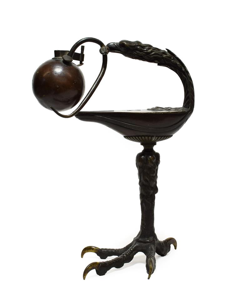 Lot 344 - A German Bronze Table Lighter, 19th century, after the antique, modelled as an oil lamp with bird's