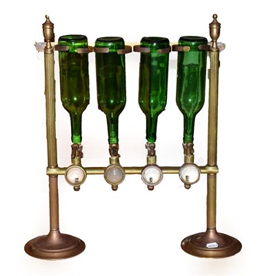 Lot 355 - A Brass Drinks' Dispenser, late 19th/early 20th century, for four bottles, with urn finials, fluted