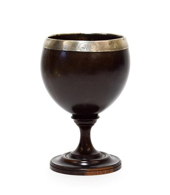 Lot 374 - A White Metal Mounted Lignum Vitae Pedestal Cup, early 19th century, of ovoid form, the rim...