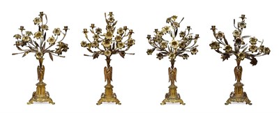 Lot 380 - A Garniture of Four French Gilt Metal Candelabra, 19th century, each as an angel supporting an...