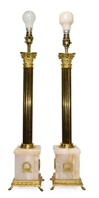 Lot 383 - A Pair of Brass and Onyx Table Lamp Bases, 20th century, as Corinthian columns on square bases...