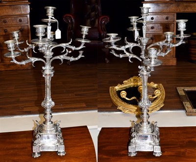 Lot 400 - A Pair of Silver Plated Seven-Light Candelabra, each on square base, the corners applied with...