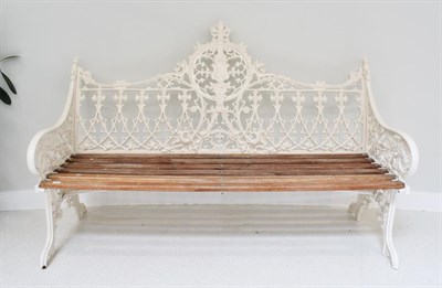 Lot 422 - A White Painted Cast Metal Garden Bench, modern, with six wooden slats and a Gothic style back...