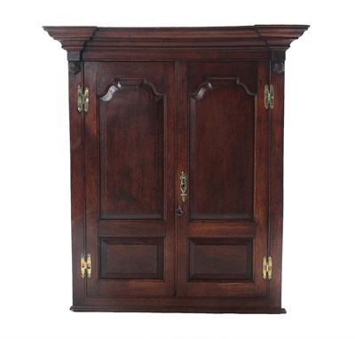 Lot 447 - A George III Oak Hanging Corner Cupboard, late 18th century, the breakfront moulded cornice...