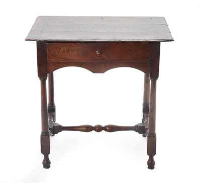 Lot 448 - An 18th Century Joined Oak and Pine Lined Side Table, the three plank top above a single frieze...