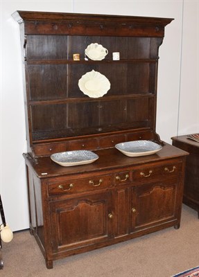 Lot 461 - A Mid 18th Century Oak Dresser, the rack with a bold cornice above five cup hooks with two...