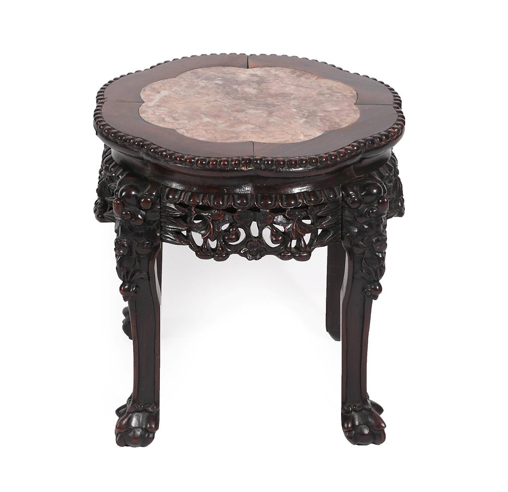 Lot 537 - An Early 20th Century Chinese Padouk Wood and Pink Marble Plant Stand, with foliate carved...