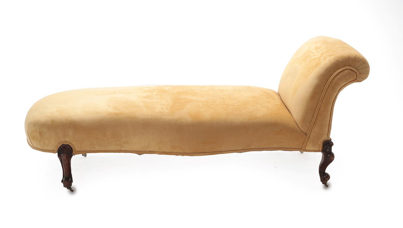 Lot 580 - A Victorian Chaise Longue, circa 1870, recovered in yellow fabric with deep overstuffed seat of...