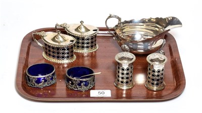 Lot 50 - A four-piece Edward VII silver condiment-set, by Haseler and Bill, Chester, 1906, each piece...