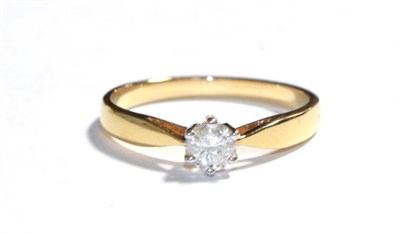 Lot 66 - An 18 carat gold diamond solitaire ring, the round brilliant cut diamond in a white claw setting to