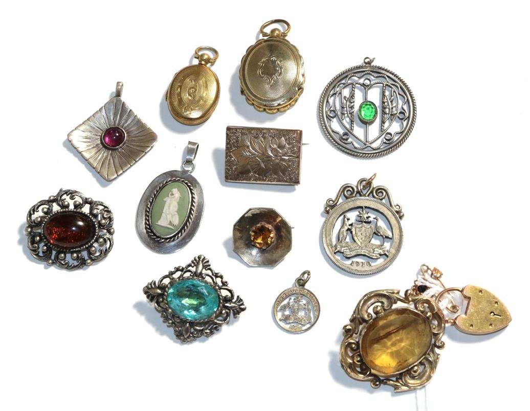 Lot 69 - A 9 carat gold gem set pendant, three white metal brooches, a plated brooch, two plated...