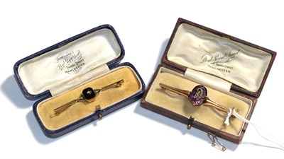 Lot 75 - An onyx and seed pearl bar brooch, indistinctly stamped, length 5.9cm and an amethyst and...