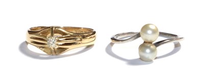 Lot 85 - An 18 carat gold diamond solitaire ring, finger size M1/2; and a cultured pearl twist ring,...