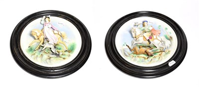 Lot 127 - A pair of Austrian porcelain plaques modelled in relief of a lady and gentleman on a hunt, diameter