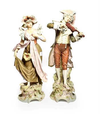 Lot 131 - A pair of post 1919 Royal Dux figures of a musician and maiden in floral shawl and bonnet,...