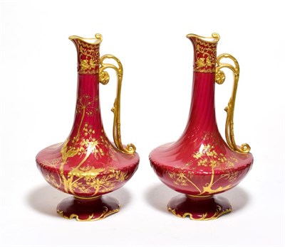 Lot 149 - A pair of Royal Crown Derby floral gilt decorated red ground ewers, 25cm high