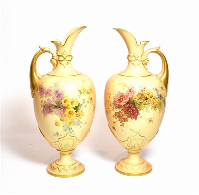 Lot 169 - A pair of Royal Worcester blush ivory floral painted ewers, shape number: 1581, 34cm high