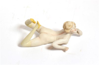 Lot 210 - An early 20th century German bisque figure of a nude young woman, unmarked, modelled lying on front