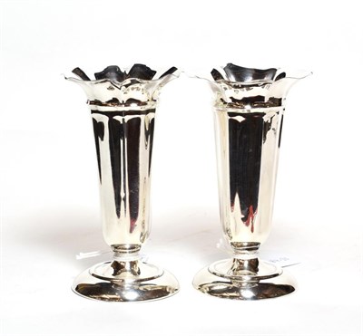 Lot 232 - A pair of Edward VII silver vases, by Deakin and Francis, Birmingham, 1909, each fluted...