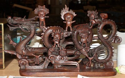 Lot 246 - An early 20th century carved hardwood figure of a dragon