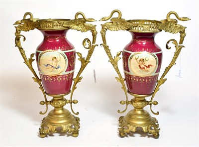 Lot 266 - A pair of gilt metal twin handled porcelain vases, decorated with classical scenes, 34cm high