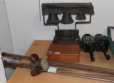 Lot 328 - Swiss bells, pair of coaching lamps, oak box, split cane rod and golf clubs