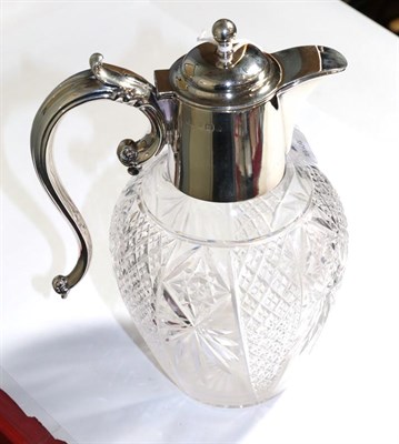 Lot 348 - A silver mounted cut glass claret jug, by Barker Bros. Birmingham, hinged lid, scroll handle