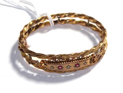 Lot 390 - A ruby and diamond hinged bangle, stamped '9CT'