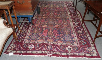 Lot 1103 - An Oriental carpet, the lilac field of stylised plants enclosed by meandering vine borders