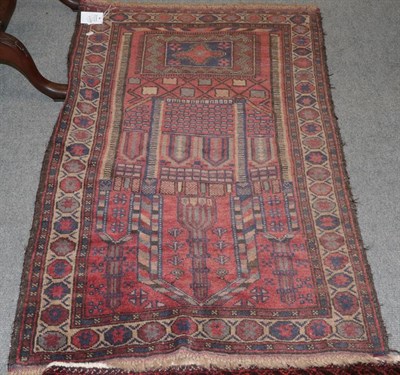 Lot 1106 - An Afghan prayer rug, the raspberry field depicting a mosque enclosed by octagon borders, 135cm...