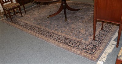 Lot 1109 - A machine made carpet of Oriental design, the pale lilac field with central medallion, 356 by 272cm