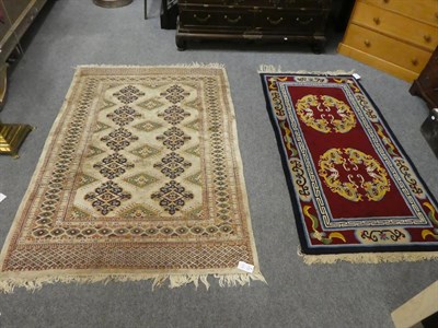 Lot 1115 - A Pakistan ''Bukhara'' rug, the ivory field of medallions enclosed by multiple borders, 187cm...