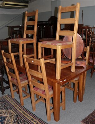 Lot 1136 - A reproduction oak dining table and six chairs