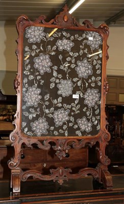 Lot 1138 - A Victorian carved walnut fire screen with floral bead work panel