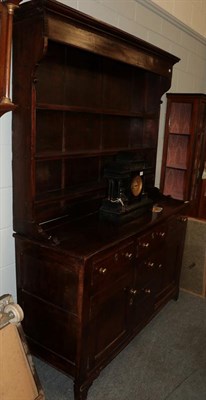 Lot 1141 - An 18th century oak and pine lined enclosed dresser and rack