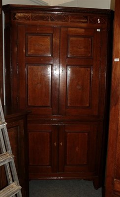 Lot 1152 - A good George III oak, mahogany and marquetry decorated free-standing corner cupboard, late...