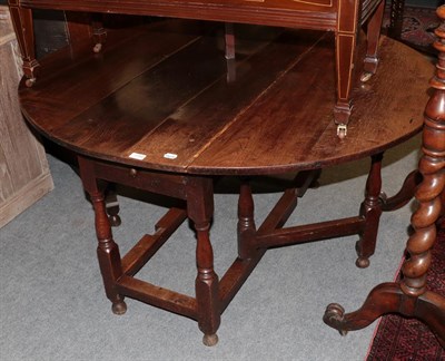 Lot 1154 - An early 18th century oak gate leg dining table