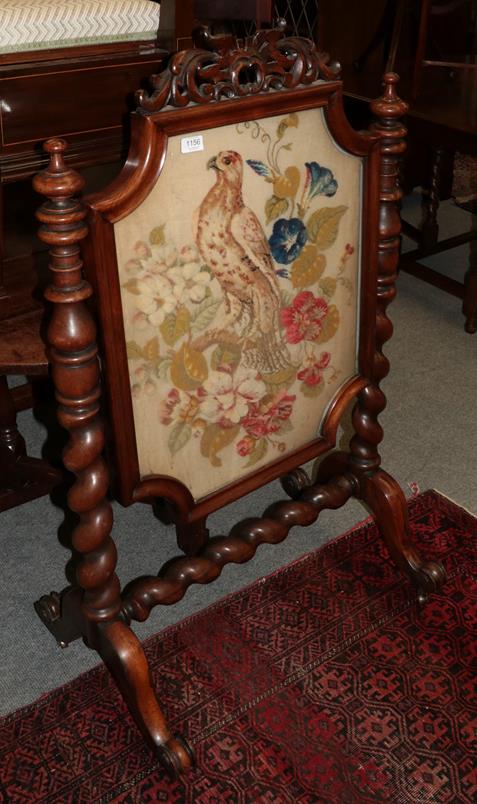 Lot 1156 - An early Victorian rosewood framed fire screen, mid 19th century, with original needlework...