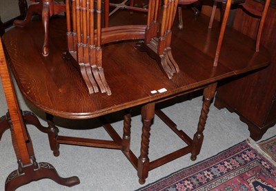 Lot 1167 - Oak gateleg dining table, small oak cabinet and an oak glazed bookcase (3)