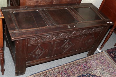 Lot 1180 - A late 17th century joined oak chest with hinged lid, pegged construction, carved foliate...