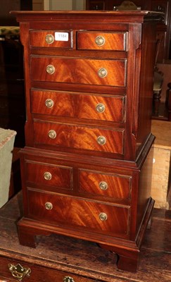 Lot 1184 - A reproduction mahogany miniature chest on chest