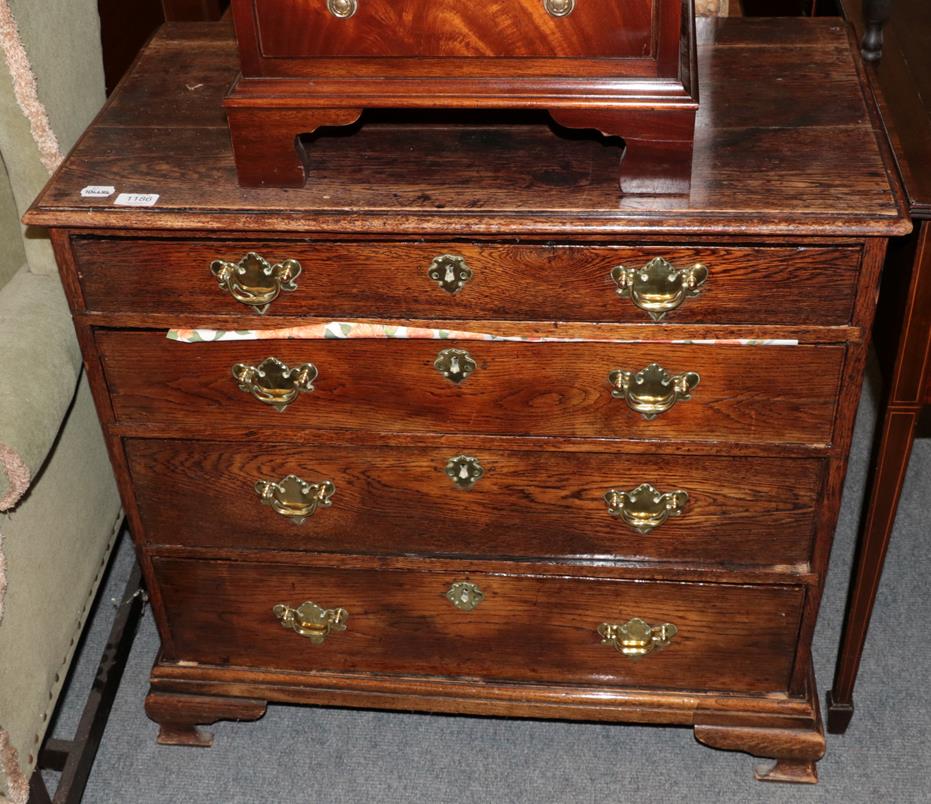 Lot 1186 - An 18th century oak four drawer chest, moulded rectangular top, brass handles and escutcheons,...