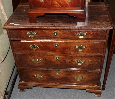 Lot 1186 - An 18th century oak four drawer chest, moulded rectangular top, brass handles and escutcheons,...