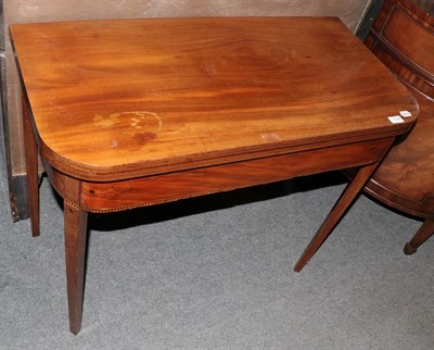 Lot 1196 - A George III inlaid mahogany fold over tea table, 74cm by 91cm by 45cm