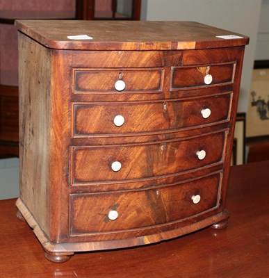 Lot 1199 - A miniature bow fronted chest of drawers