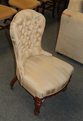Lot 1209 - A Victorian walnut nursing chair in button fabric
