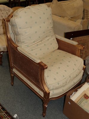 Lot 1210 - A Louis XVI style gilt and cane bergère chair