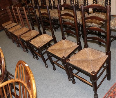 Lot 1215 - A set of four 19th century elm ladder back dining chairs together with another similar set of...