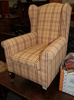 Lot 1224 - A, Edwardian child's winged armchair, upholstered in striped fabric with square tapering legs...